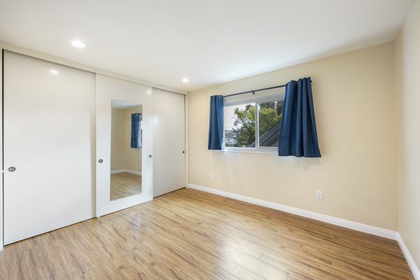 View of sliding doors, hardwood floors, and window