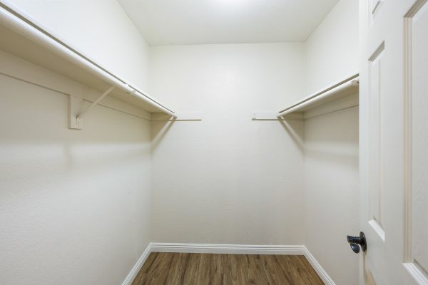 Closet with hanging racks on opposite walls