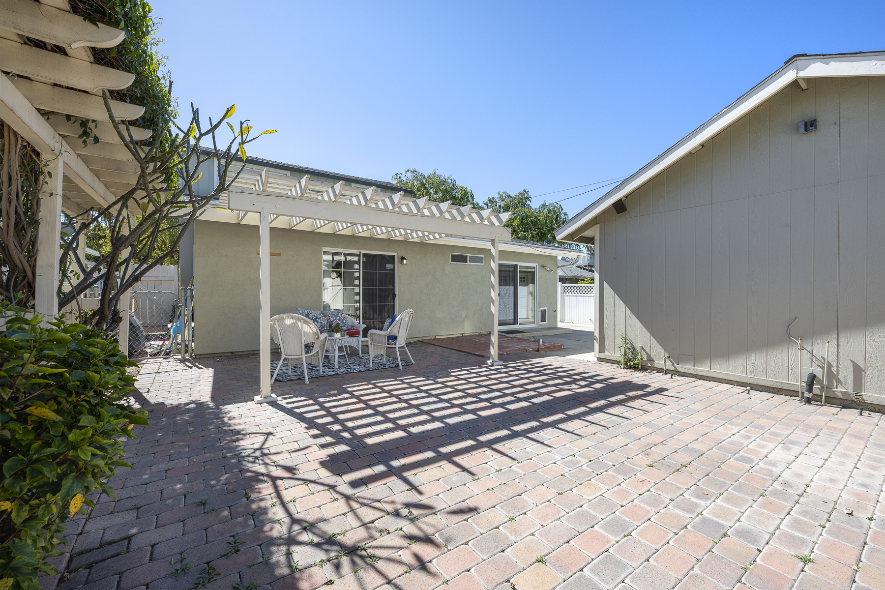 1229 Grove Place Fullerton CA 92831: Courtyard with pergola and rear of home with fence on the left