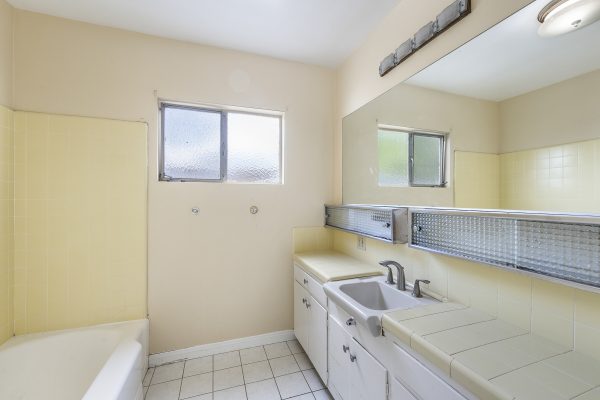 501 Dorothy Drive: Full bathroom view with sinks, lights and window