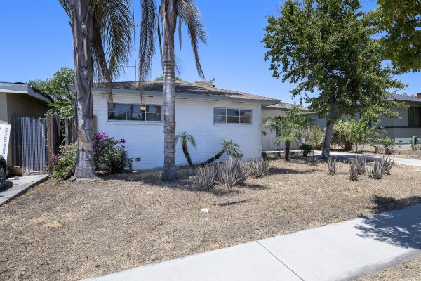 319 E. Francis Ave, La Habra, CA 90631: Exterior shot of front of house and yard, angled.