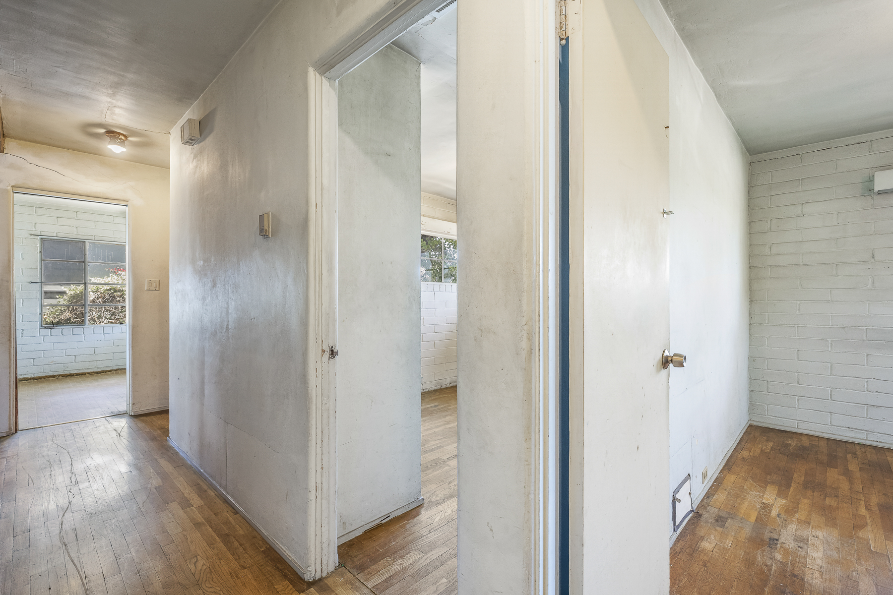 319 E. Francis Ave, La Habra, CA 90631: Interior hallway to three white brick rooms shot.