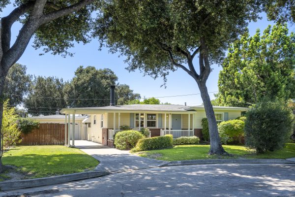 411 Truman Ave, Fullerton, CA 92832: Street view of home and large trees in front yard.