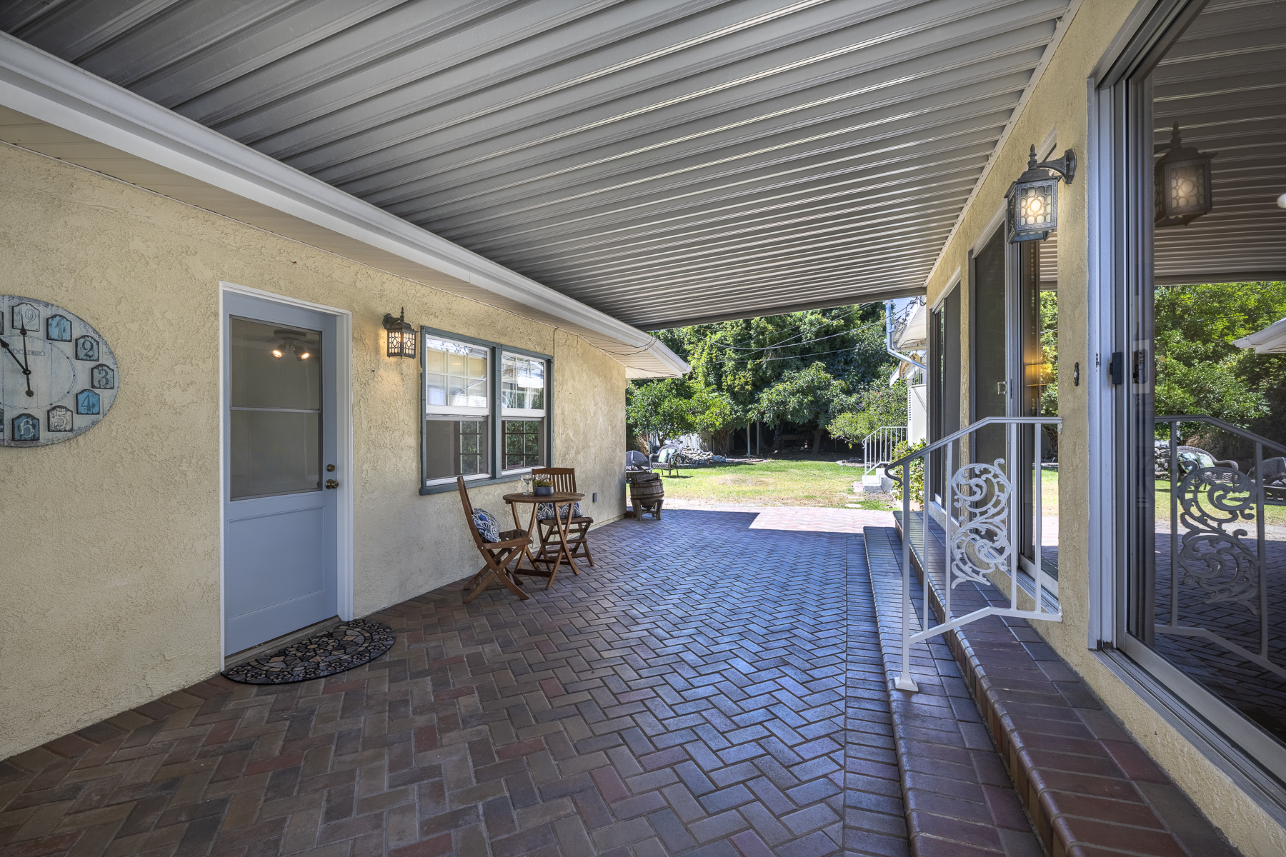 411 Truman Ave, Fullerton, CA 92832: Exterior view of covered patio and iron railing.