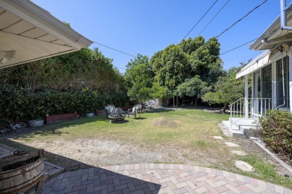 411 Truman Ave, Fullerton, CA 92832: Backyard side view with fire pit.