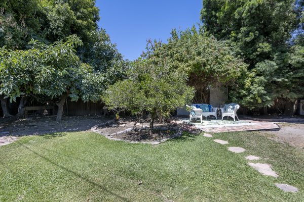 411 Truman Ave, Fullerton, CA 92832: Brick paver patio with outdoor furniture and trees.