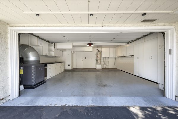 3424 Pinebrook Costa Mesa CA 92626: Open garage with a plethora of cabinets and storage space.
