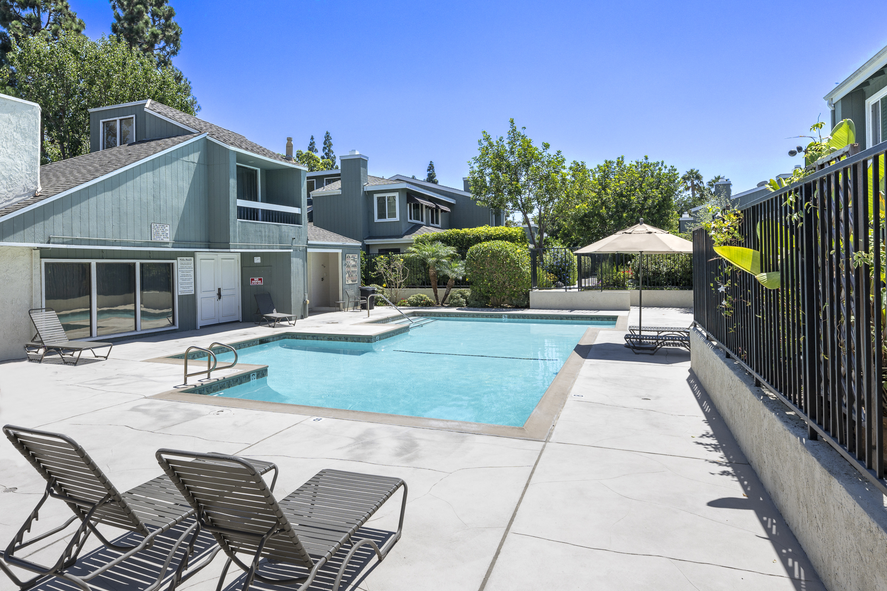 3424 Pinebrook Costa Mesa CA 92626: Pool with pool house and green landscaping.