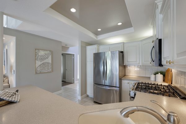 3424 Pinebrook Costa Mesa CA 92626: Kitchen picture with hallway leading to kitchen plus bar and stove.